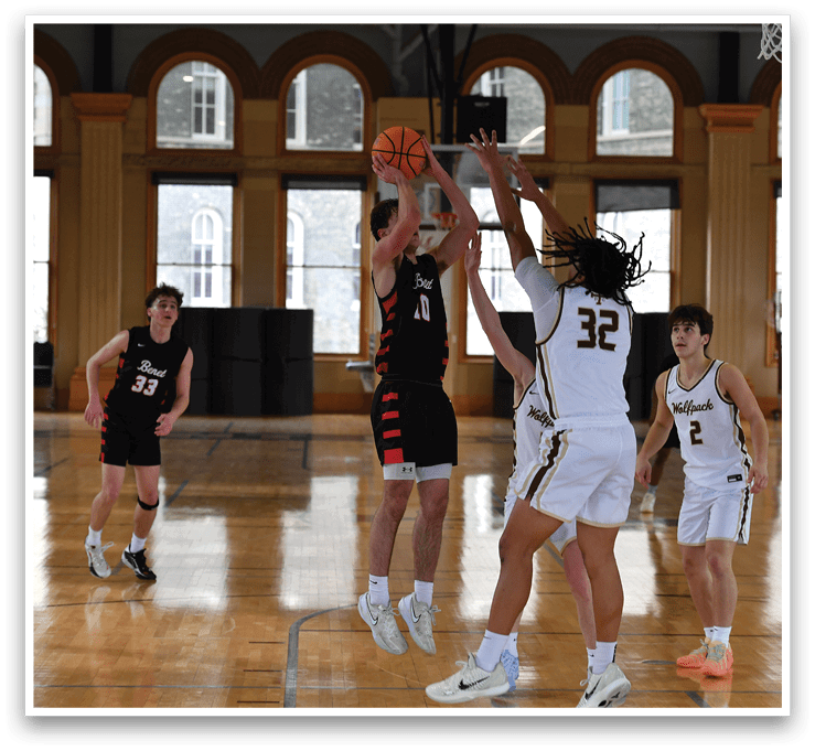 A group of men playing basketball in a gym. One player is jumping to block a shot. AI generated content