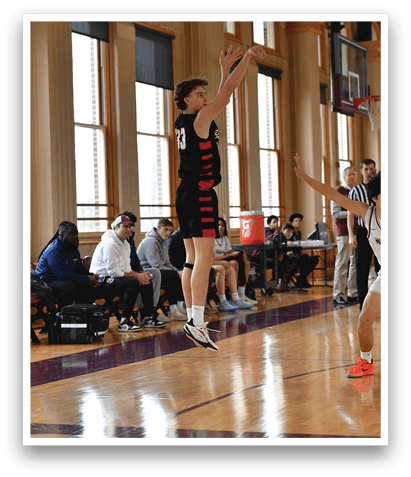 A group of young men playing basketball in a gym. AI generated content