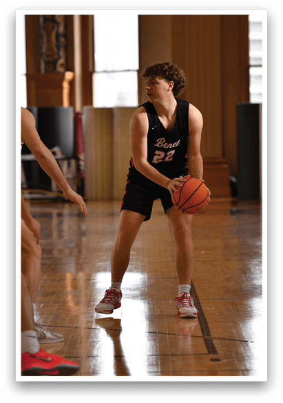 Two men playing basketball in a gym. AI generated content