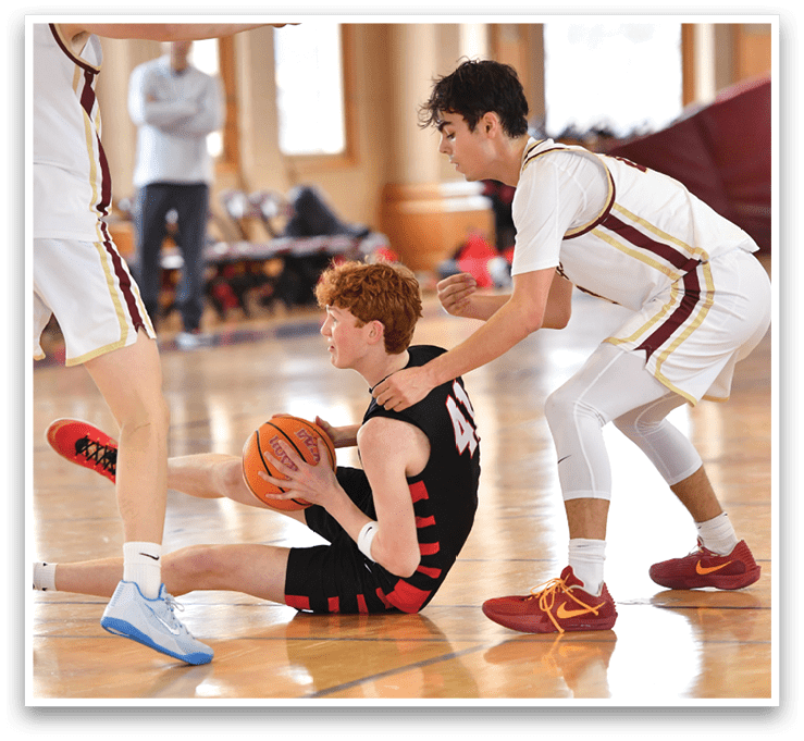 A man is on the floor holding a basketball, while another man tries to take the ball from him. AI generated content