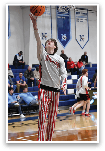 A boy in a basketball game is reaching for the ball. AI generated content