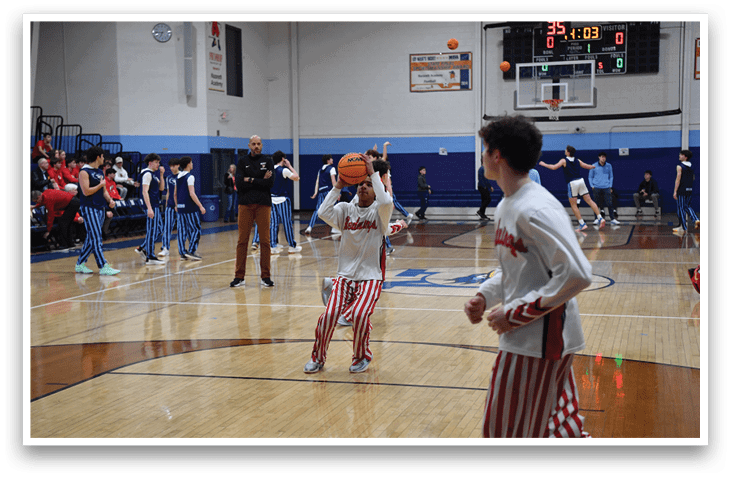 A basketball game is taking place with a group of men on the court. One man is holding a basketball, while another man is holding a basketball hoop. There are several other men on the court, some of them wearing striped pants. The scene is lively and full of action. AI generated content