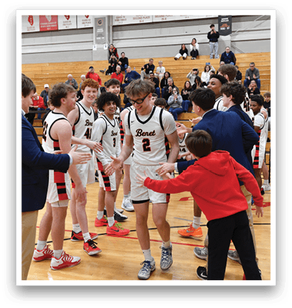 A group of young men are hugging each other on a basketball court. AI generated content