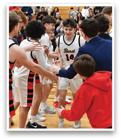 A group of young men and a boy are hugging each other on a basketball court. AI generated content