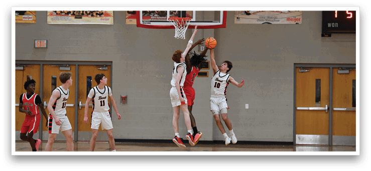 A basketball player leaps to block a shot, while his teammates watch. AI generated content