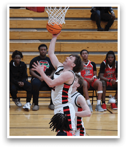 A basketball player is jumping to block a shot, while a crowd of people watch from the stands. AI generated content