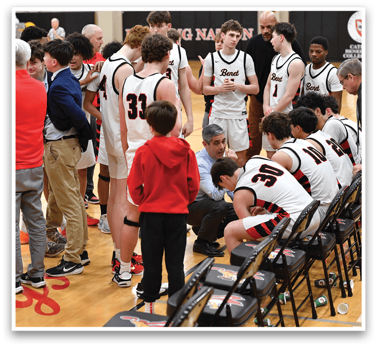 A group of people are gathered on a basketball court, some sitting on chairs and others standing. They are engaged in a conversation, possibly discussing the game or strategizing. The scene is lively and focused, with everyone's attention on the same direction. AI generated content