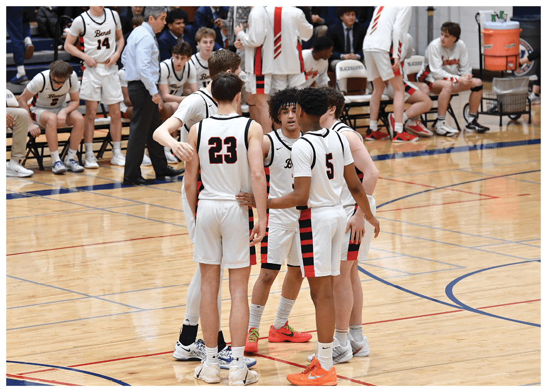 A group of young men are standing on a basketball court, engaged in a conversation. AI generated content