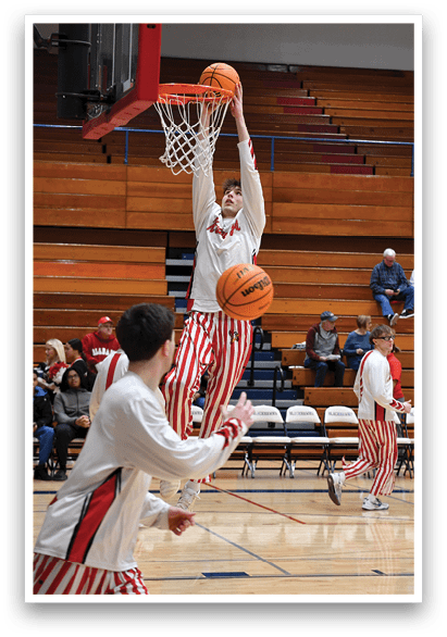 A basketball player is jumping to dunk the ball into the hoop. AI generated content