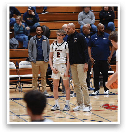 A group of people are standing on a basketball court, with some of them wearing uniforms. A man in a white uniform is holding a basketball. AI generated content