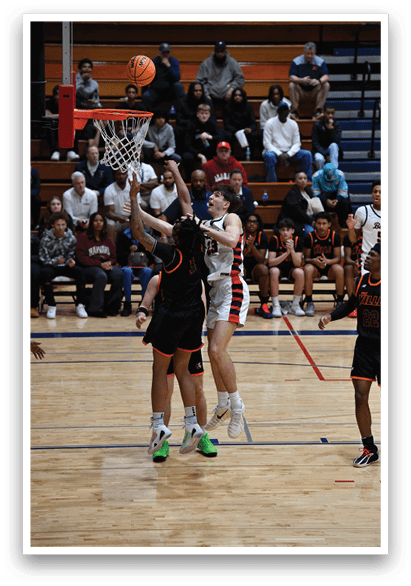 Basketball players on a court, one of them jumping to block a shot. AI generated content