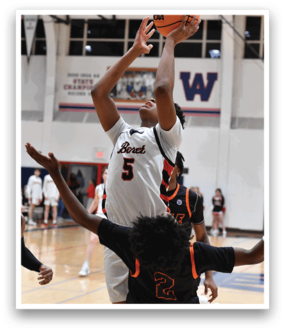 A basketball player is attempting to shoot the ball while being blocked by another player. AI generated content