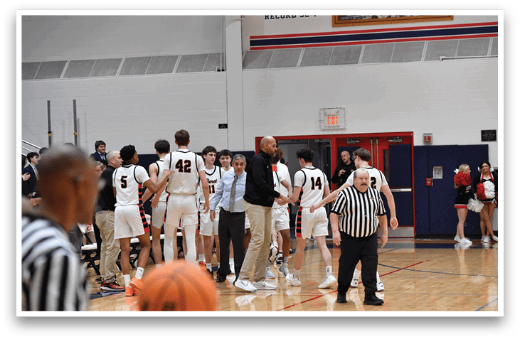 A group of basketball players huddle together on the court. AI generated content