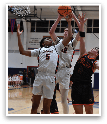 A basketball game is in progress with two men playing for the ball. One man is holding the ball and the other is trying to block him. The players are wearing uniforms and are in the middle of the court. AI generated content