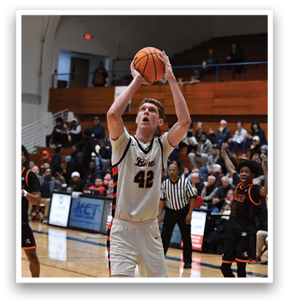 A basketball player is jumping to block a shot, while other players are running on the court. AI generated content