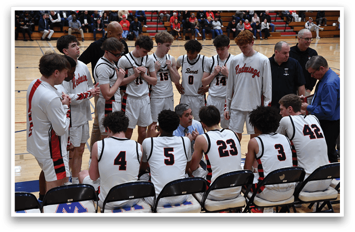 A group of young men wearing basketball uniforms are sitting on chairs on a basketball court. AI generated content