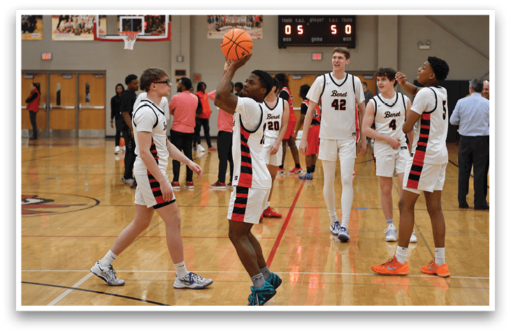 A group of young men playing basketball in a gym. AI generated content