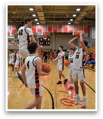 A group of basketball players on a court, some of them jumping in the air to catch the ball. AI generated content