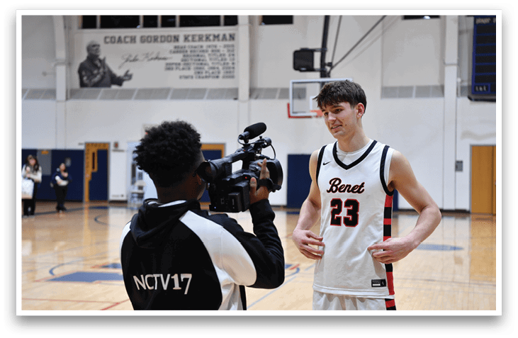 A man wearing a basketball jersey with the number 23 stands in front of a camera. AI generated content