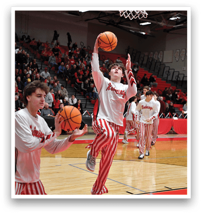 Two men wearing striped pants are playing basketball. One man is holding a basketball while the other is reaching for it. AI generated content