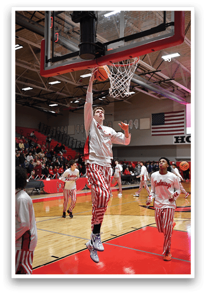 A basketball player is jumping to dunk the ball through the hoop. AI generated content