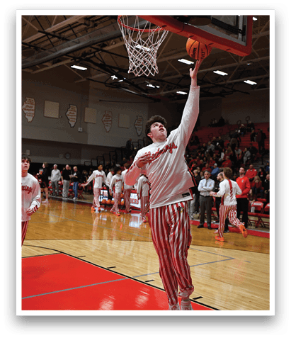 A basketball player in a white shirt and red and white striped pants leaps to dunk a basketball. AI generated content