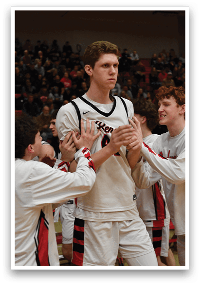 A group of young men are hugging and congratulating a player on the basketball court. AI generated content