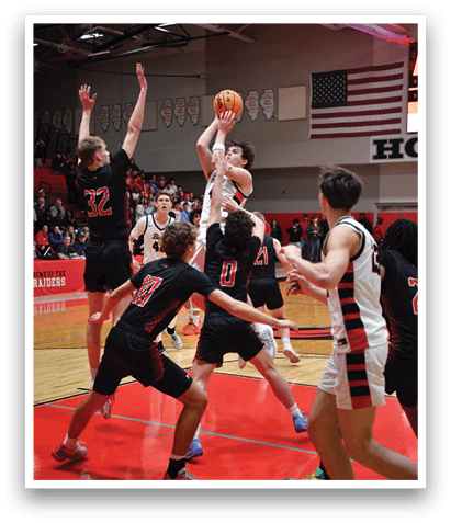 A group of men playing basketball, with one man attempting to block the shot of another player. AI generated content
