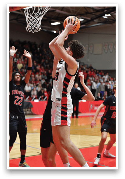 A basketball player is attempting to block a shot, while the crowd looks on. AI generated content