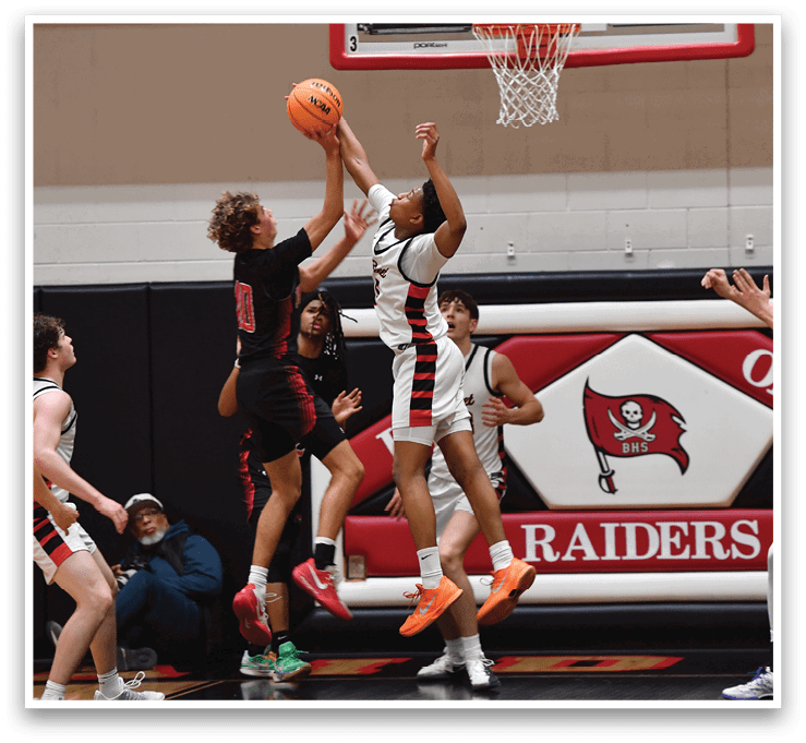 Basketball players in action, one player is jumping to block a shot. AI generated content