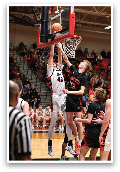 A basketball player is jumping to hit the ball, while a referee watches the play. AI generated content