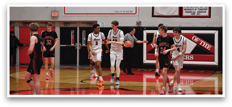 A group of young men playing basketball on a court. AI generated content