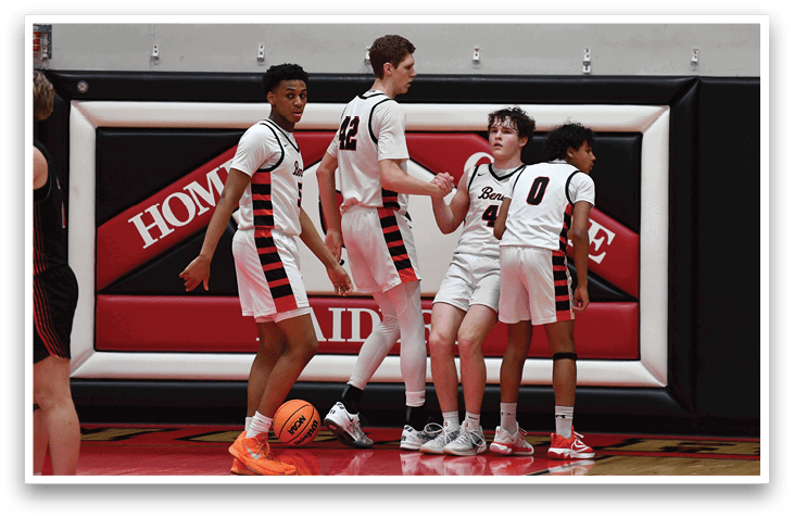 A group of young men are standing on a basketball court, some holding basketballs. AI generated content