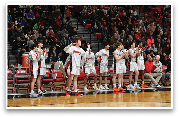 A group of young men are standing on a basketball court, wearing uniforms and holding their hands up. They are likely celebrating a victory or preparing for a game. AI generated content
