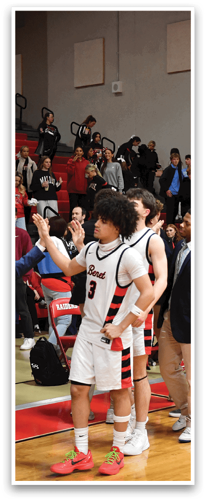 A group of young men in suits and ties are lined up on a basketball court, shaking hands with each other. AI generated content