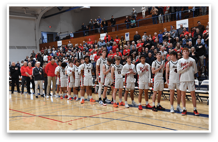 A group of young men in uniforms stand on a basketball court, waiting for the game to start. AI generated content