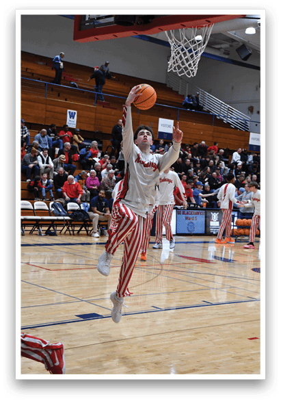 A basketball player in a striped shirt and shorts is jumping to hit a basketball. AI generated content