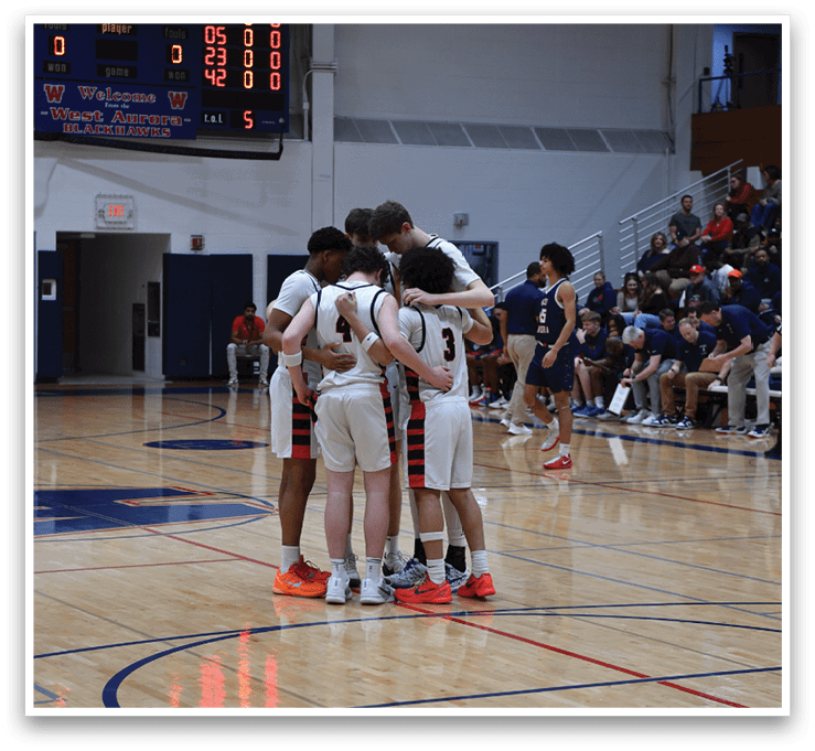 A group of basketball players huddle together on the court. AI generated content