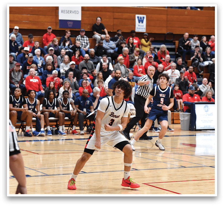 A basketball game is taking place with a group of people playing. A boy is holding a basketball and is about to throw it. There are several other people on the court, some of whom are wearing uniforms. The spectators are watching the game from the stands. AI generated content