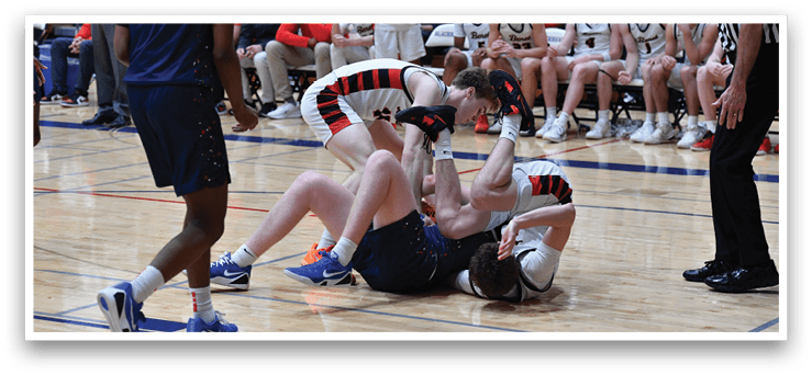 Two boys are wrestling on the basketball court, with one boy on top of the other. The referee is watching the match closely. AI generated content