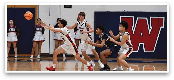 A group of people playing basketball, with one person trying to block the ball. AI generated content