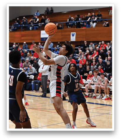 A basketball player is reaching for the ball while another player tries to block him. The player trying to block is wearing a red shoe. AI generated content