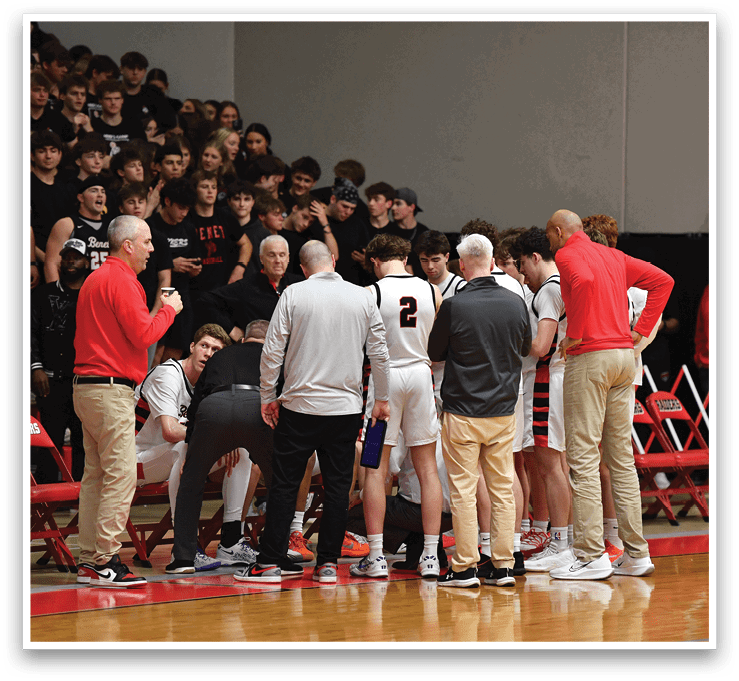 A group of men are gathered on a basketball court, with some sitting on chairs and others standing. They are wearing uniforms and appear to be discussing something. The scene takes place in front of a crowd, suggesting that this might be a game or an event. AI generated content