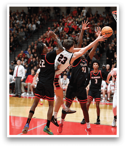 A group of basketball players are playing a game. One player is trying to block the ball from going into the basket. AI generated content