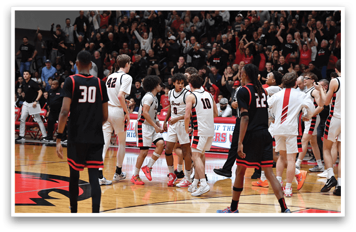 A group of men in black and red uniforms are celebrating on a basketball court. AI generated content