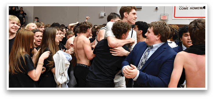 A group of people, including a man wearing a suit, are hugging and celebrating. AI generated content