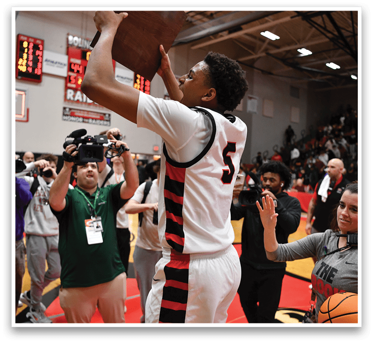 A basketball player holds a trophy above his head while a crowd of people watch. AI generated content