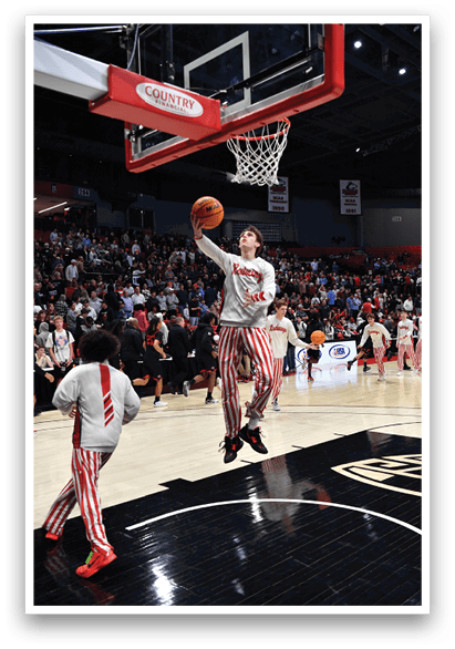 A basketball player is jumping to hit the ball in a game. AI generated content