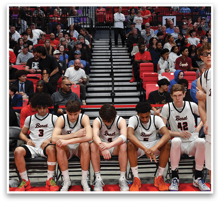 A group of basketball players are sitting on a bench, watching the game. AI generated content