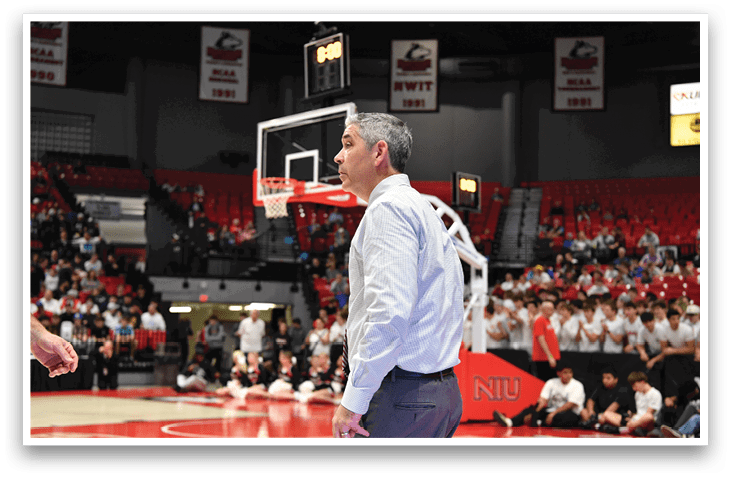 Two men are talking on a basketball court. AI generated content